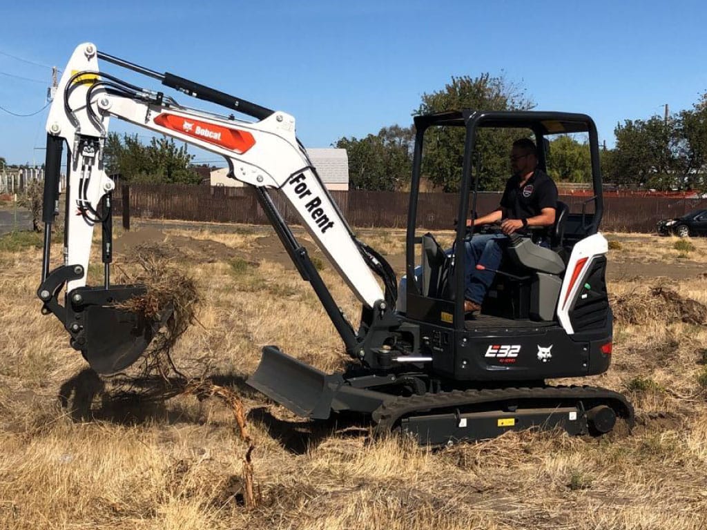 Bobcat E32 Excavator for large stump root extraction in Tri-Cities WA